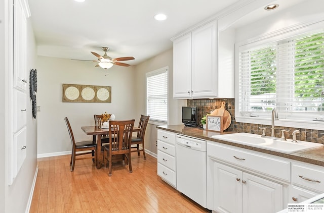 6641 S 85th St, Ralston, NE 68127 - kitchen with dishwasher, a sink, tasteful backsplash, a ceiling fan, and baseboards