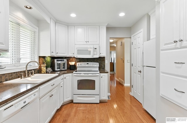 6641 S 85th St, Ralston, NE 68127 - kitchen featuring white appliances, a sink, dark countertops, decorative backsplash, and recessed lighting