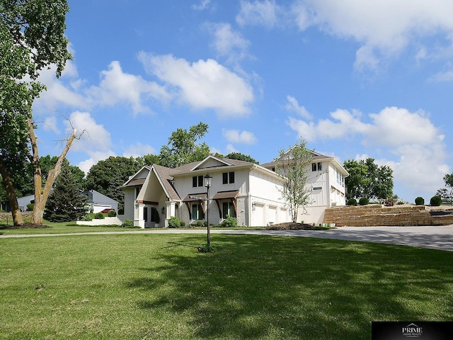 20640 Rawhide Rd, Omaha, NE 68022 - view of front of house featuring a garage, a front lawn, stucco siding, and driveway