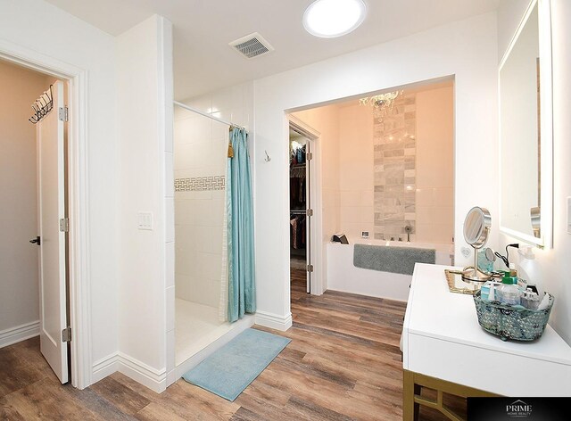20640 Rawhide Rd, Omaha, NE 68022 - bathroom with a tile shower, wood finished floors, vanity, a chandelier, and baseboards
