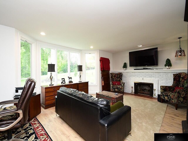 20640 Rawhide Rd, Omaha, NE 68022 - living room featuring light wood finished floors, a brick fireplace, and recessed lighting
