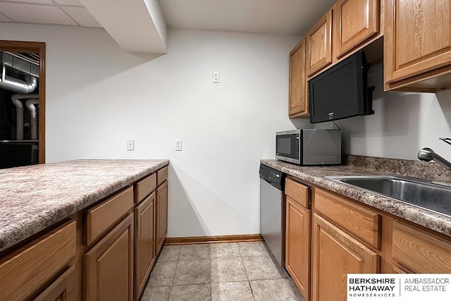 5360 S 174th Ave, Omaha, NE 68135 - kitchen with appliances with stainless steel finishes, a sink, brown cabinets, and baseboards