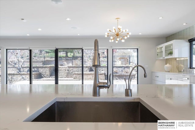 1312 S 78th St, Omaha, NE 68124 - kitchen featuring plenty of natural light, a sink, a chandelier, recessed lighting, and white cabinets