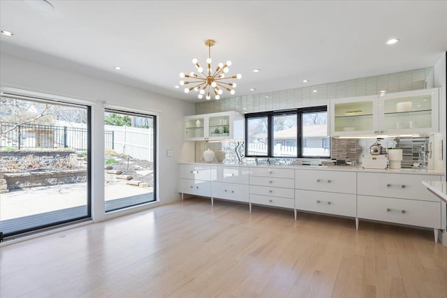 1312 S 78th St, Omaha, NE 68124 - bar with tasteful backsplash, a chandelier, light wood-type flooring, decorative light fixtures, and recessed lighting
