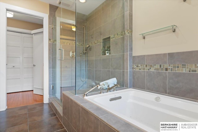 1312 S 78th St, Omaha, NE 68124 - bathroom with a stall shower, a garden tub, tile patterned floors, and tile walls