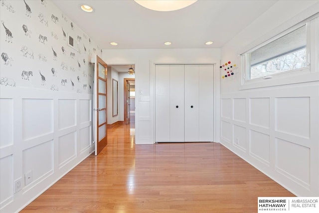 1312 S 78th St, Omaha, NE 68124 - unfurnished bedroom with wallpapered walls, a decorative wall, a wainscoted wall, recessed lighting, and light wood-type flooring