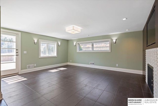 1312 S 78th St, Omaha, NE 68124 - unfurnished living room with a fireplace, baseboards, and recessed lighting