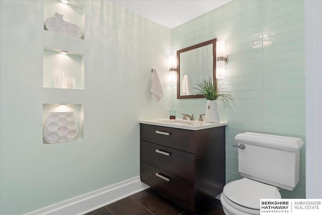 1312 S 78th St, Omaha, NE 68124 - bathroom featuring vanity, toilet, and wood finished floors