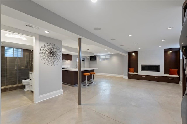 1312 S 78th St, Omaha, NE 68124 - basement featuring baseboards, bar, a large fireplace, and recessed lighting