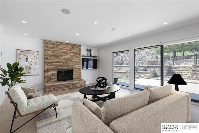 1312 S 78th St, Omaha, NE 68124 - living area with recessed lighting, a stone fireplace, and wood finished floors