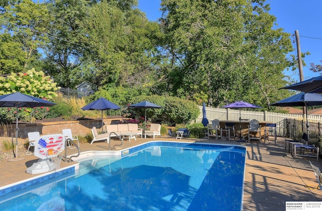 1312 S 78th St, Omaha, NE 68124 - view of pool featuring a fenced backyard, a patio area, view of scattered trees, and outdoor dining space