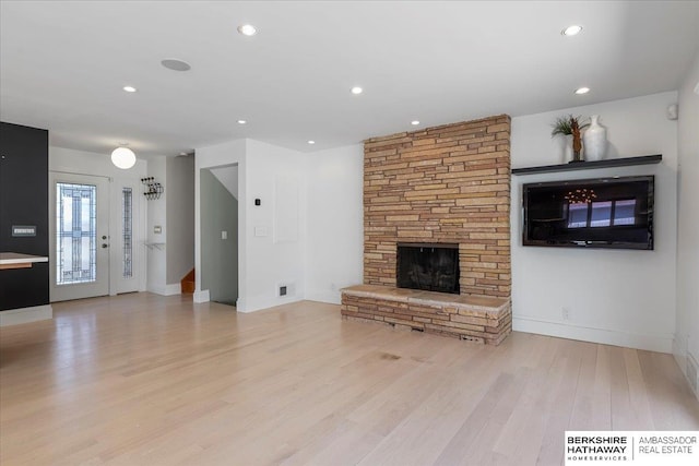 1312 S 78th St, Omaha, NE 68124 - unfurnished living room featuring a stone fireplace, light wood finished floors, baseboards, and recessed lighting