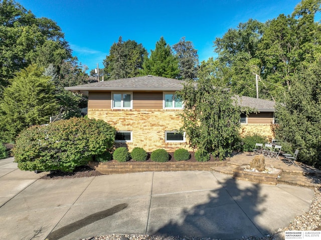 1312 S 78th St, Omaha, NE 68124 - view of side of property featuring brick siding and a patio area