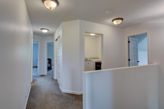 10505 Rosewater Pkwy, Bennington, NE 68007 - hall with washer and clothes dryer, carpet floors, baseboards, and a textured ceiling