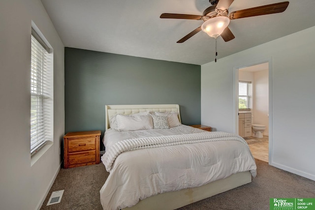 10505 Rosewater Pkwy, Bennington, NE 68007 - bedroom with carpet floors, ensuite bathroom, and baseboards
