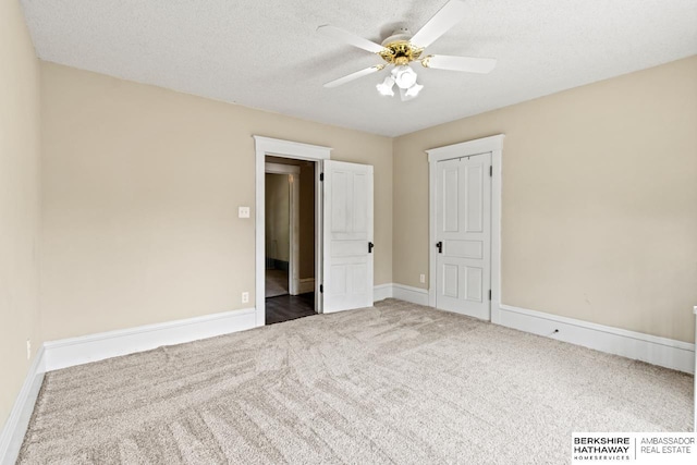 646 W 8th St, Fremont, NE 68025 - unfurnished bedroom featuring carpet flooring, baseboards, a textured ceiling, and ceiling fan