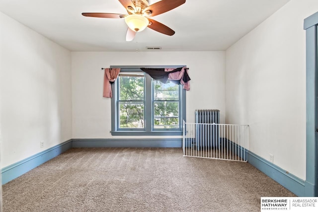 646 W 8th St, Fremont, NE 68025 - carpeted spare room featuring radiator, a ceiling fan, and baseboards