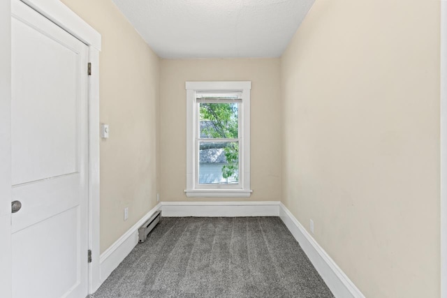 646 W 8th St, Fremont, NE 68025 - carpeted empty room with baseboard heating, a textured ceiling, and baseboards