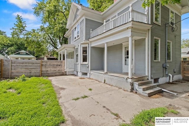 646 W 8th St, Fremont, NE 68025 - view of side of home featuring covered porch and a balcony