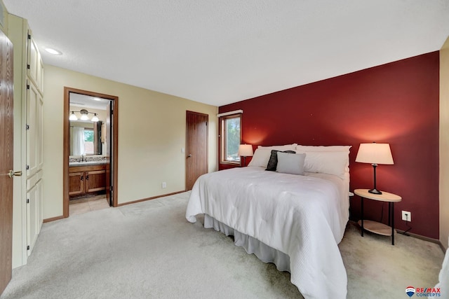 4321 S 58th St Unit 5, Lincoln, NE 68516 - bedroom featuring light carpet, multiple windows, baseboards, and ensuite bathroom