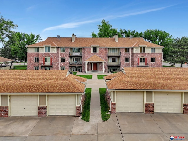 4321 S 58th St Unit 5, Lincoln, NE 68516 - multi unit property featuring brick siding, a chimney, and community garages