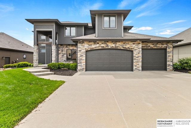 1220 S 200th Ave, Omaha, NE 68130 - prairie-style house featuring concrete driveway, a front lawn, stucco siding, stone siding, and an attached garage