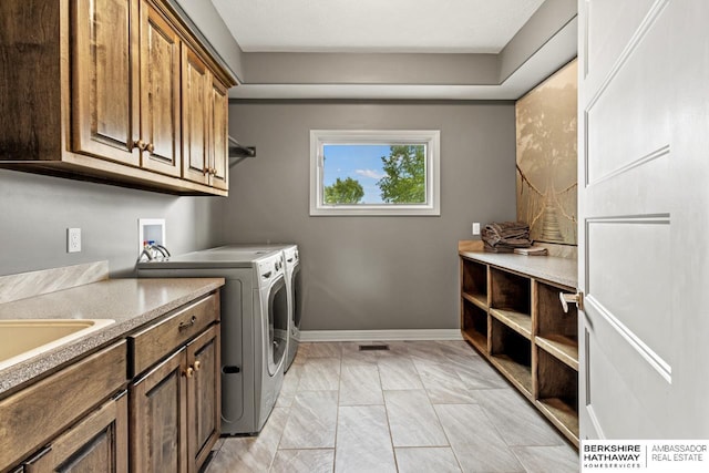 1220 S 200th Ave, Omaha, NE 68130 - washroom with cabinet space, washer and clothes dryer, and baseboards
