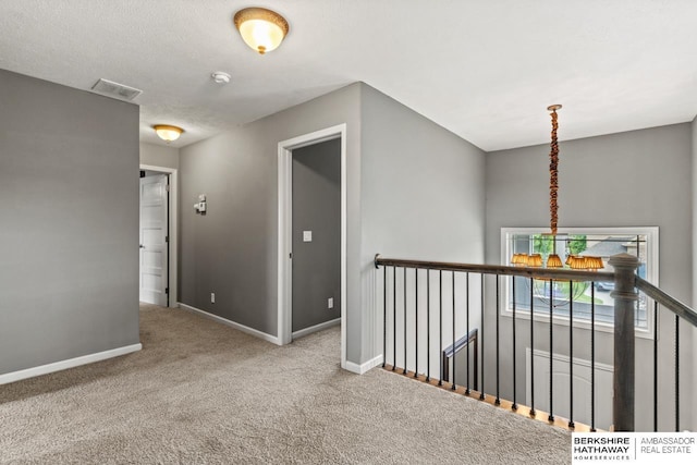 1220 S 200th Ave, Omaha, NE 68130 - hallway featuring baseboards, carpet, and an upstairs landing