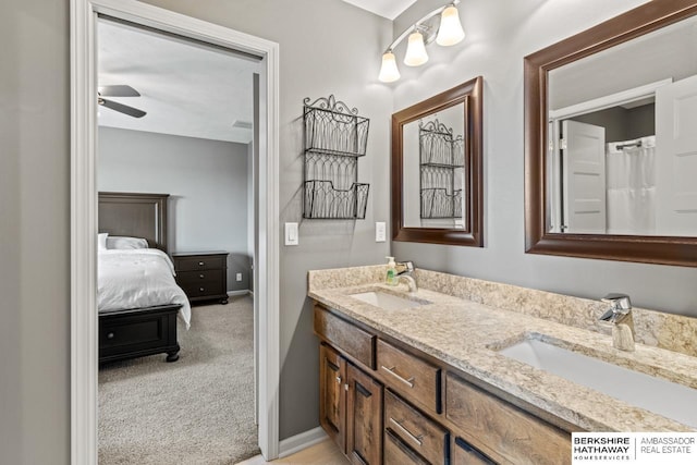 1220 S 200th Ave, Omaha, NE 68130 - ensuite bathroom featuring double vanity, ceiling fan, and baseboards
