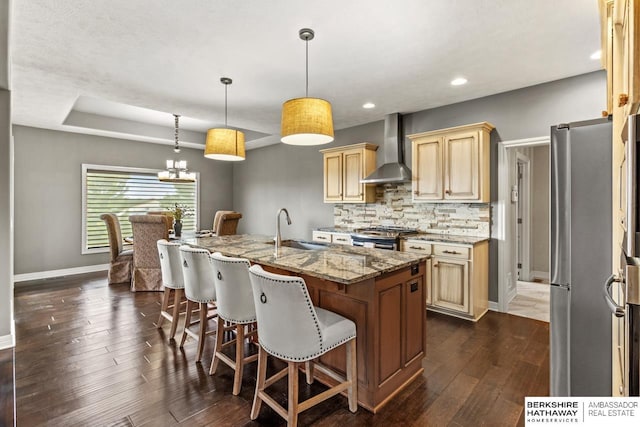 1220 S 200th Ave, Omaha, NE 68130 - kitchen with wall chimney range hood, a sink, stainless steel appliances, baseboards, and light stone countertops