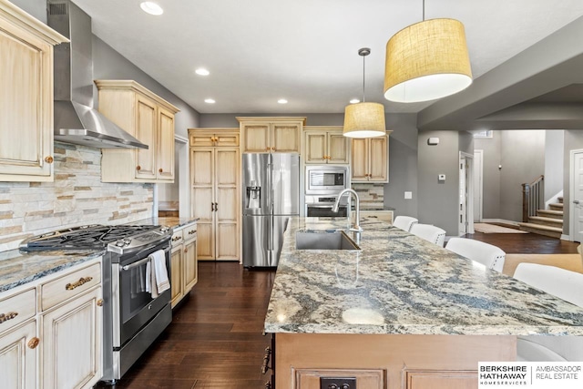 1220 S 200th Ave, Omaha, NE 68130 - kitchen with appliances with stainless steel finishes, wall chimney exhaust hood, a sink, recessed lighting, and light stone countertops