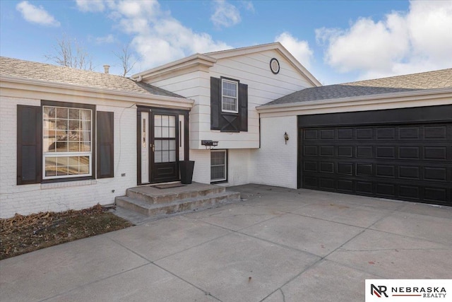 1615 S 136th St, Omaha, NE 68144 - split level home featuring brick siding, driveway, and a garage