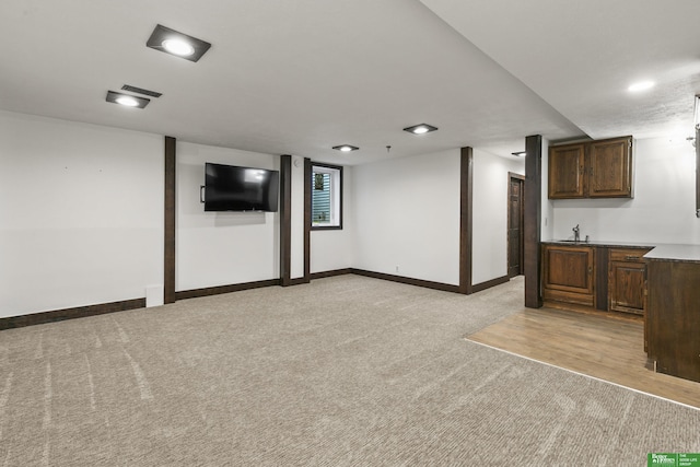 8259 Paradise Hills Ln, Fort Calhoun, NE 68023 - basement with light colored carpet, baseboards, and a sink