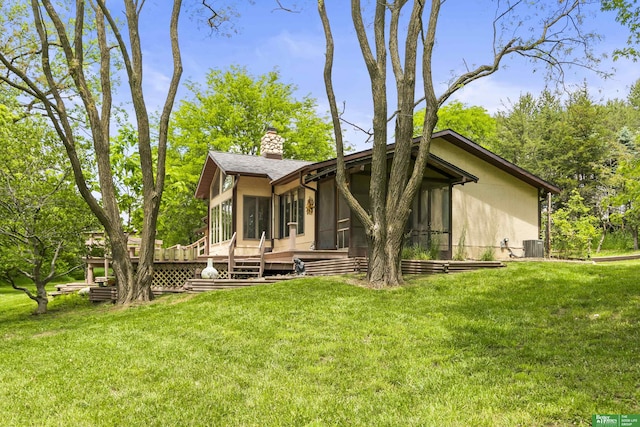 8259 Paradise Hills Ln, Fort Calhoun, NE 68023 - view of property exterior with a sunroom, a chimney, a lawn, and a deck