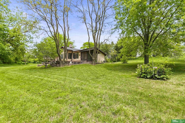 8259 Paradise Hills Ln, Fort Calhoun, NE 68023 - view of grassy yard with a sunroom and a deck