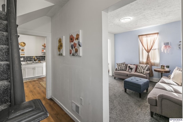 5335 N 26th St, Omaha, NE 68111 - living room featuring baseboards, dark wood-style flooring, and a textured ceiling