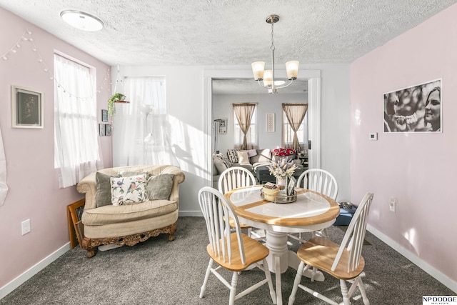 5335 N 26th St, Omaha, NE 68111 - dining room with a textured ceiling, carpet floors, baseboards, and a chandelier