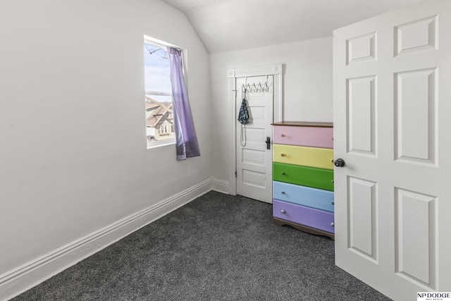 5335 N 26th St, Omaha, NE 68111 - unfurnished bedroom featuring dark colored carpet, lofted ceiling, and baseboards