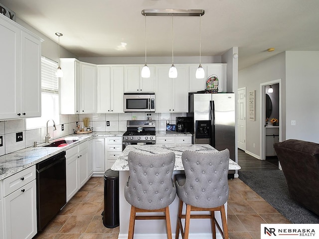 7941 N 152nd St, Bennington, NE 68007 - kitchen featuring stainless steel appliances, a sink, tasteful backsplash, and light stone counters