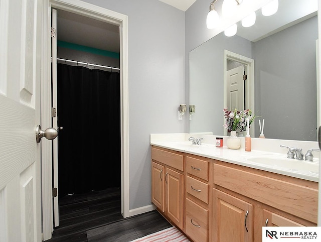 7941 N 152nd St, Bennington, NE 68007 - bathroom with double vanity, wood finished floors, and baseboards