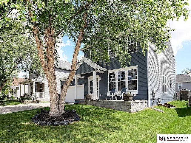 7941 N 152nd St, Bennington, NE 68007 - view of front of home featuring a front yard, a porch, a garage, and driveway