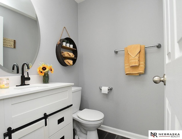 7941 N 152nd St, Bennington, NE 68007 - bathroom featuring vanity, toilet, baseboards, and wood finished floors