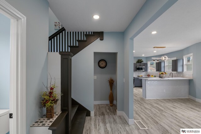 2306 Ogden St, Omaha, NE 68110 - stairs with wood finished floors, recessed lighting, and baseboards