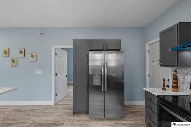 2306 Ogden St, Omaha, NE 68110 - kitchen featuring stainless steel fridge, baseboards, black electric range, light wood finished floors, and gray cabinets