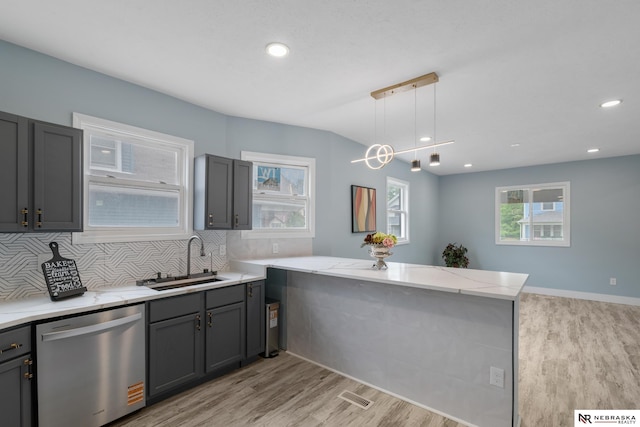2306 Ogden St, Omaha, NE 68110 - kitchen featuring stainless steel dishwasher, a sink, a peninsula, light wood-style flooring, and recessed lighting