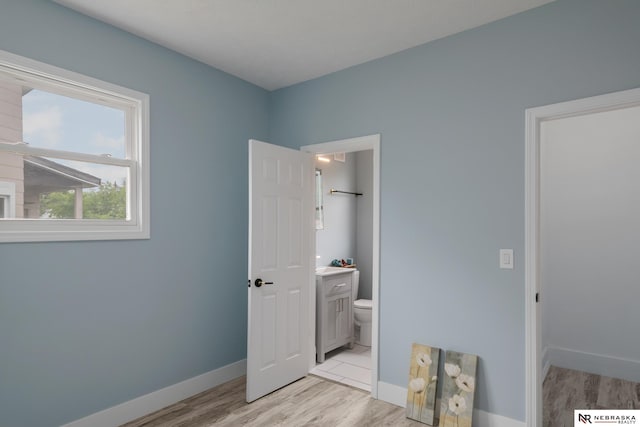 2306 Ogden St, Omaha, NE 68110 - bedroom featuring light wood-style flooring, baseboards, and ensuite bathroom