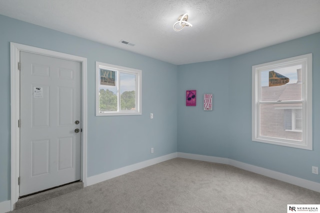 2306 Ogden St, Omaha, NE 68110 - unfurnished room with baseboards, carpet floors, and a textured ceiling
