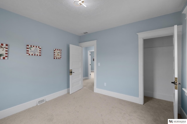 2306 Ogden St, Omaha, NE 68110 - unfurnished bedroom with carpet, a closet, baseboards, and a textured ceiling