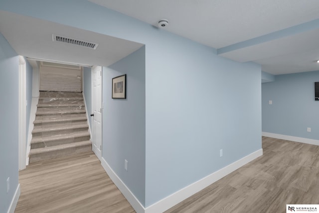 2306 Ogden St, Omaha, NE 68110 - hallway with stairway, wood finished floors, and baseboards