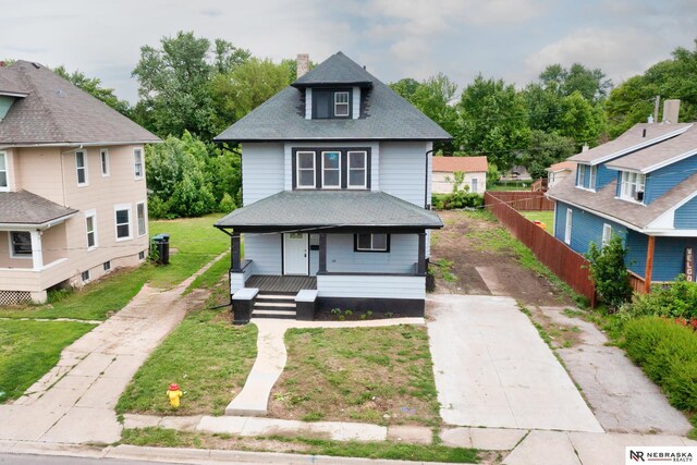 2306 Ogden St, Omaha, NE 68110 - american foursquare style home with concrete driveway, covered porch, a chimney, and a shingled roof